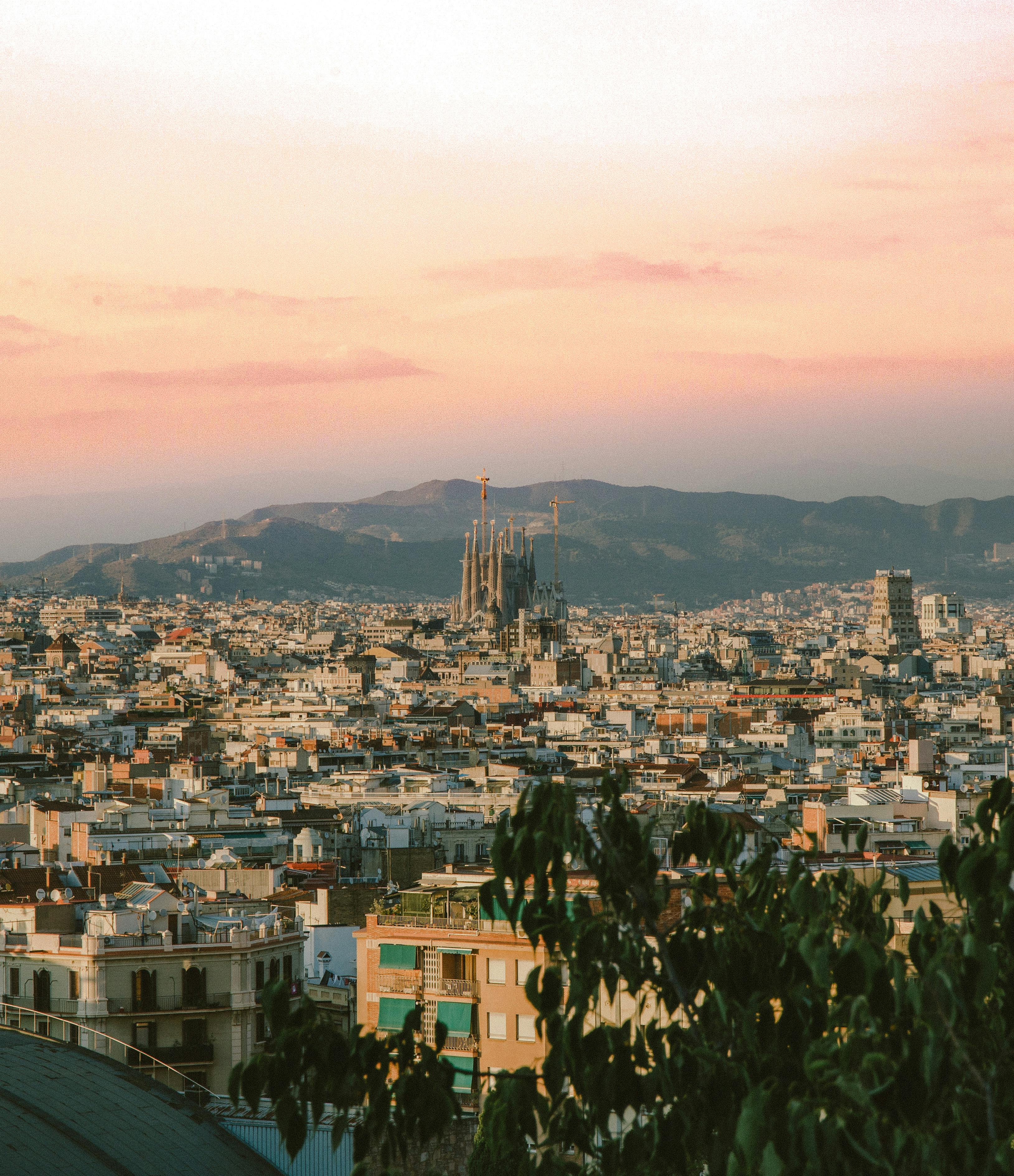 Barcelona skyline at sunset with the Sagrada Familia in view.